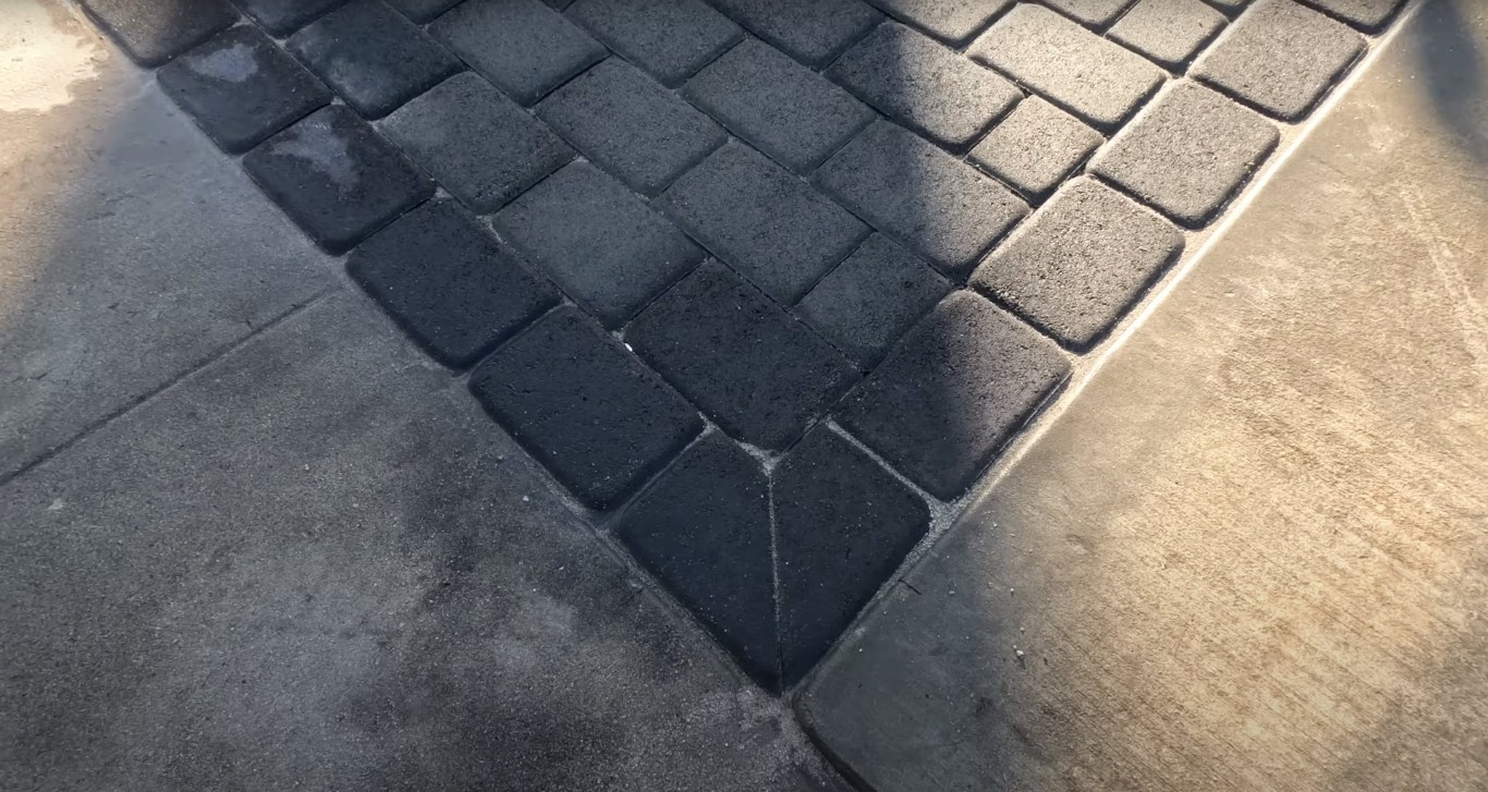 Close-up detail of stamped decorative concrete with intricate paver pattern
